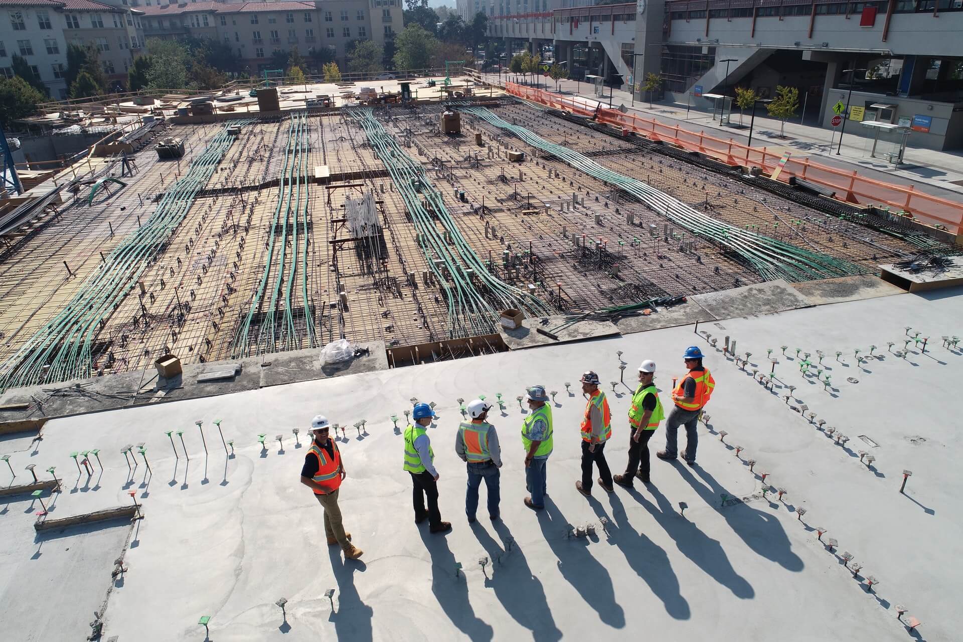 Group of construction workers overlooking a secure construction site