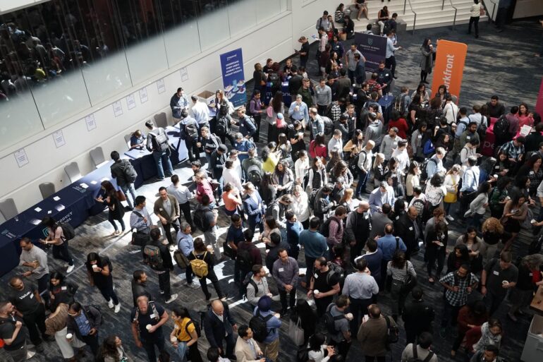 Group of people at a convention or trade show going through a security check point
