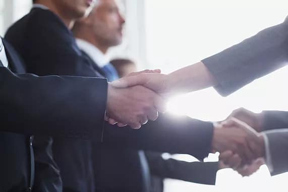 People shaking hands in a meeting